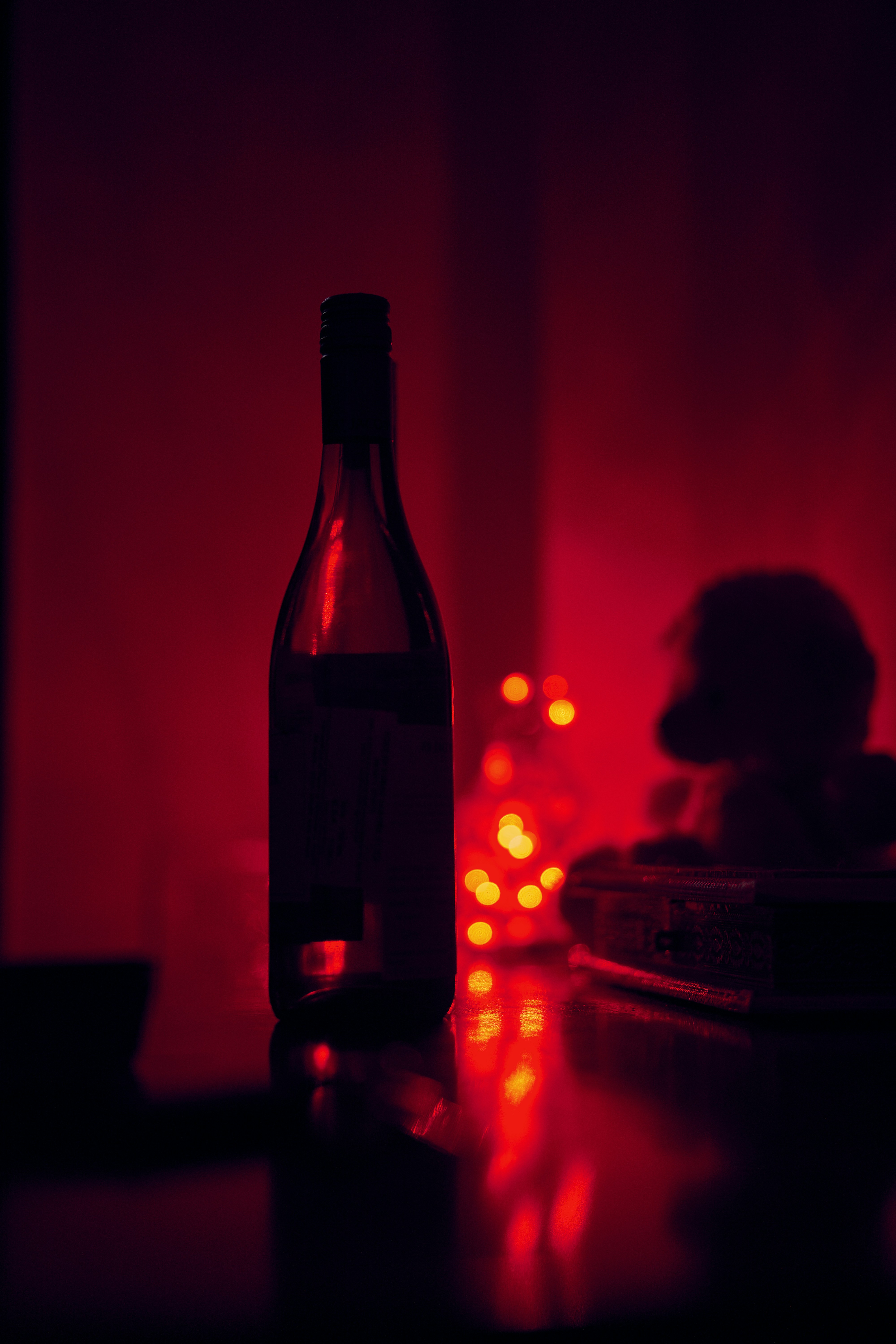 A bottle of  Jacob's Creek wine with red light in background