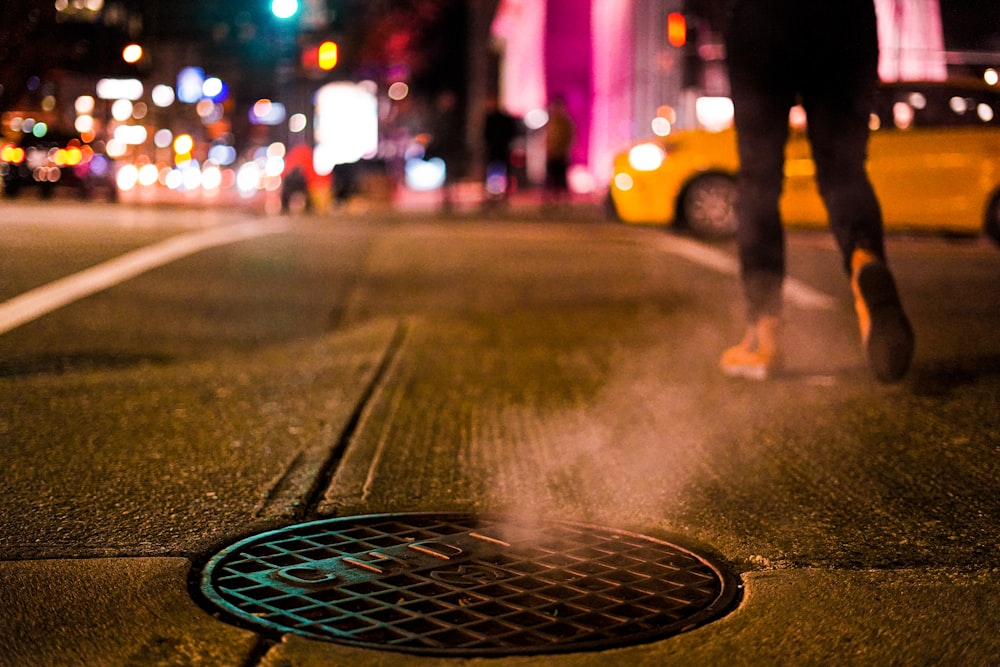 person walking on street during night time