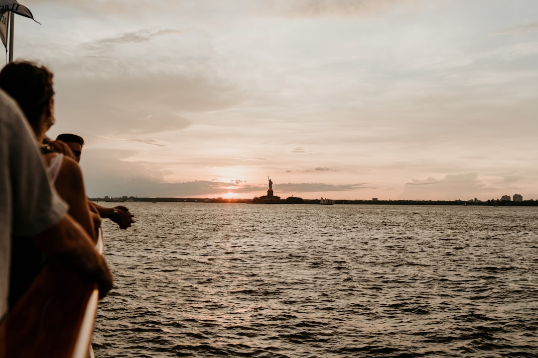 man in black shorts on sea during sunset