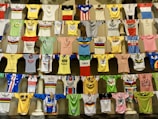 A collection of colorful sports jerseys displayed on hangers.