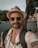 man in white jacket wearing brown fedora hat