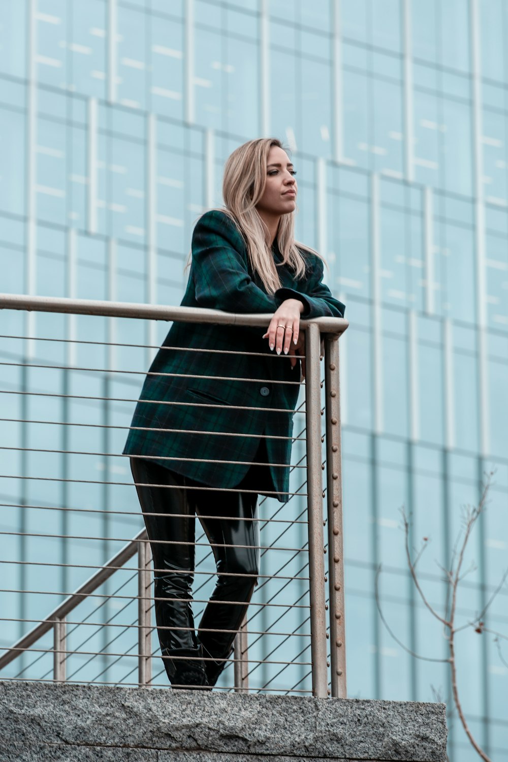 woman in black long sleeve dress standing on black metal railings