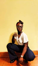 A person doing bodyweight squats in a bright, cozy living room.