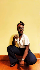 A person doing bodyweight squats in a bright, cozy living room.