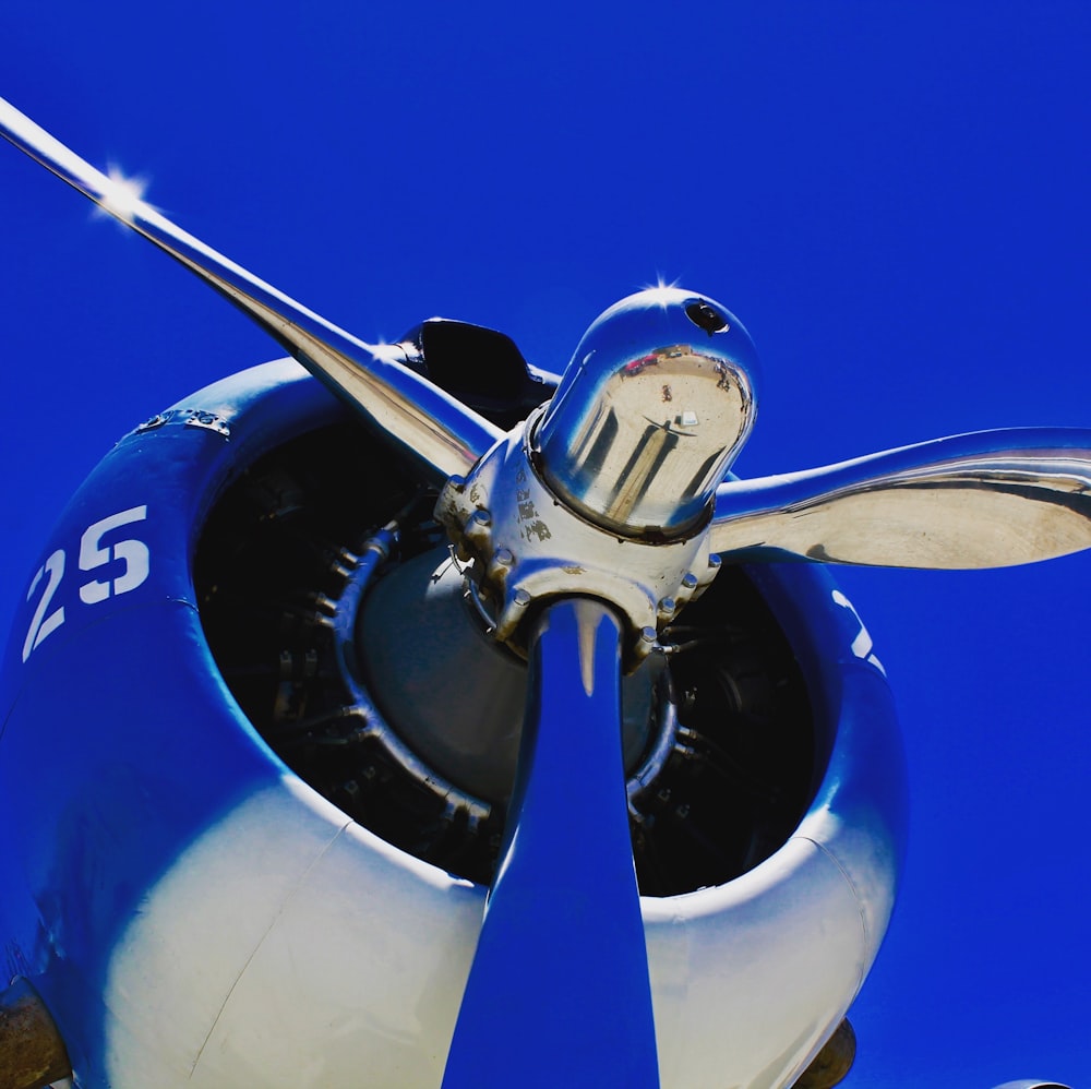 blue and white plane under blue sky during daytime