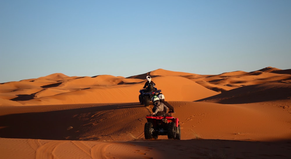 man riding atv on desert during daytime