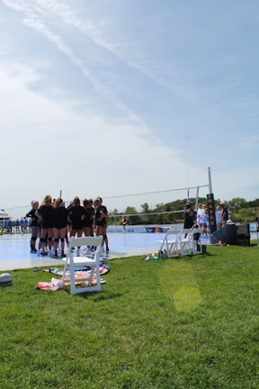 A hobby volleyball team huddled together before a friendly game.