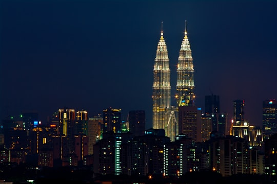 high rise building during night time in Petronas Towers Malaysia