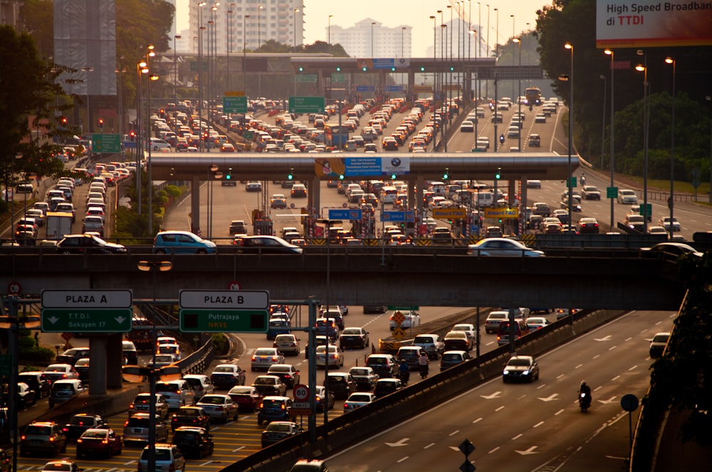 cars on road near city buildings during daytime