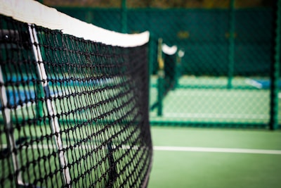 Close-up of a tennis ball hitting the net during an intense rally.