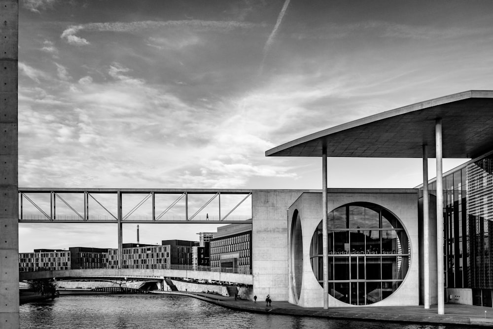 grayscale photo of building near body of water