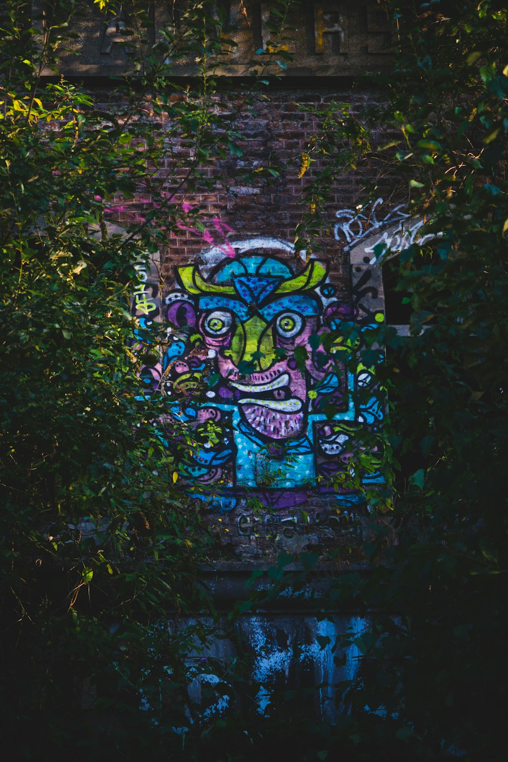 green and purple graffiti on wall