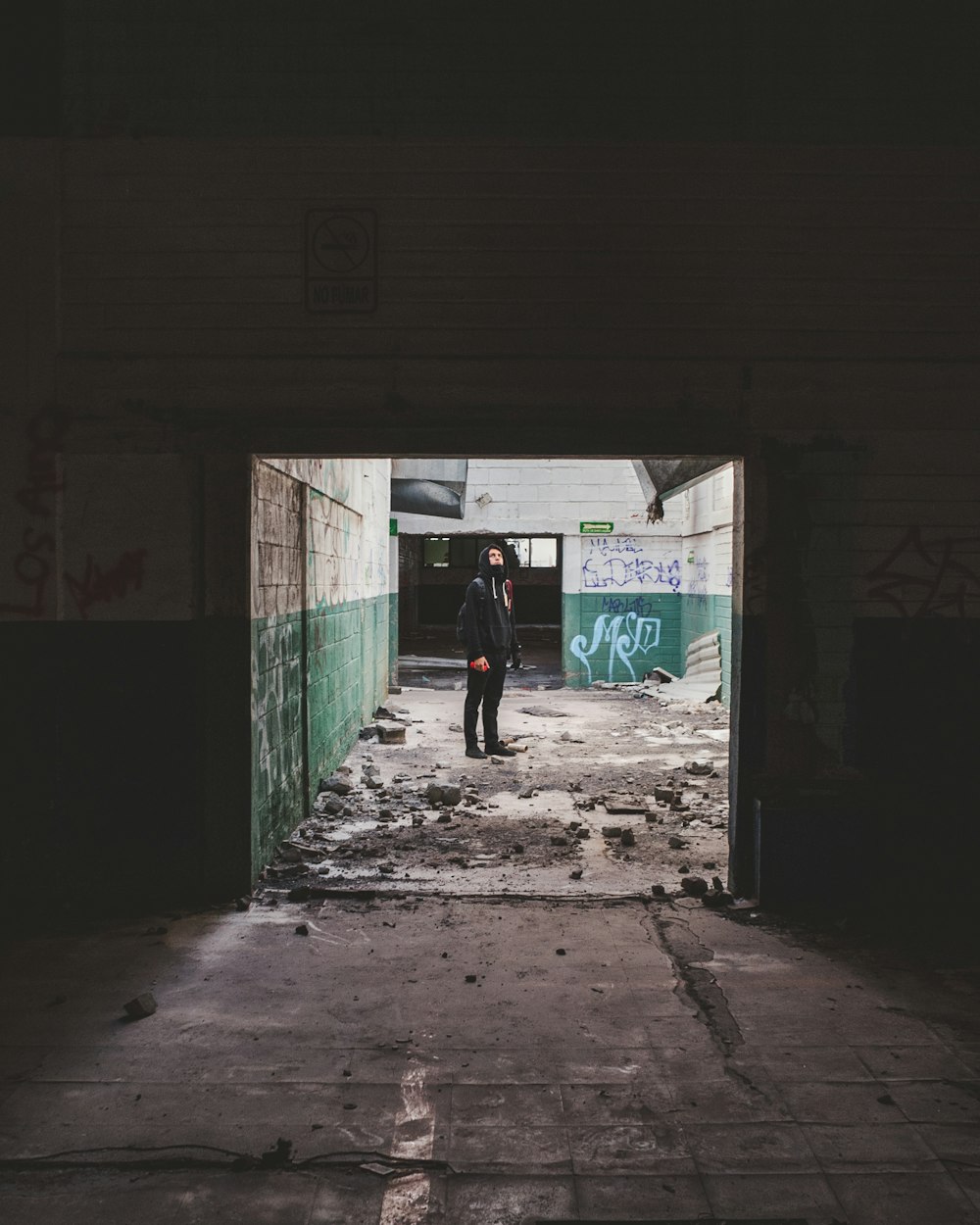 man in black jacket walking on sidewalk during daytime