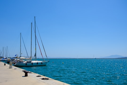 white sailboat on sea under blue sky during daytime in Volos Greece