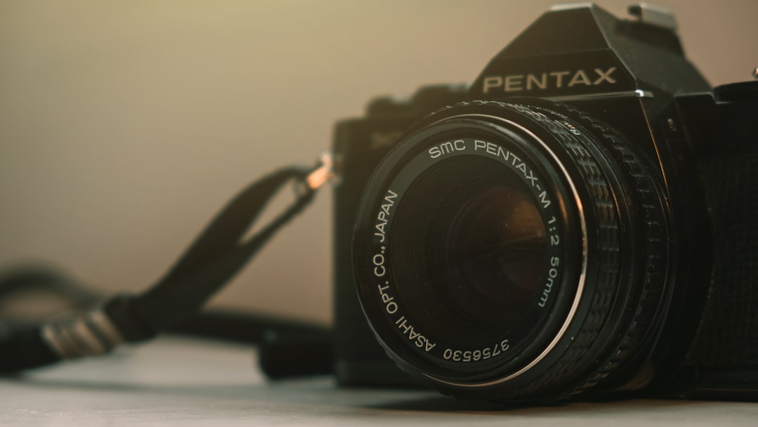 black nikon dslr camera on white table