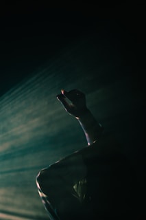 A cinematic scene capturing emotional movement in a dim theater.