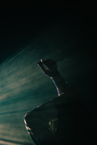 A cinematic scene capturing emotional movement in a dim theater.