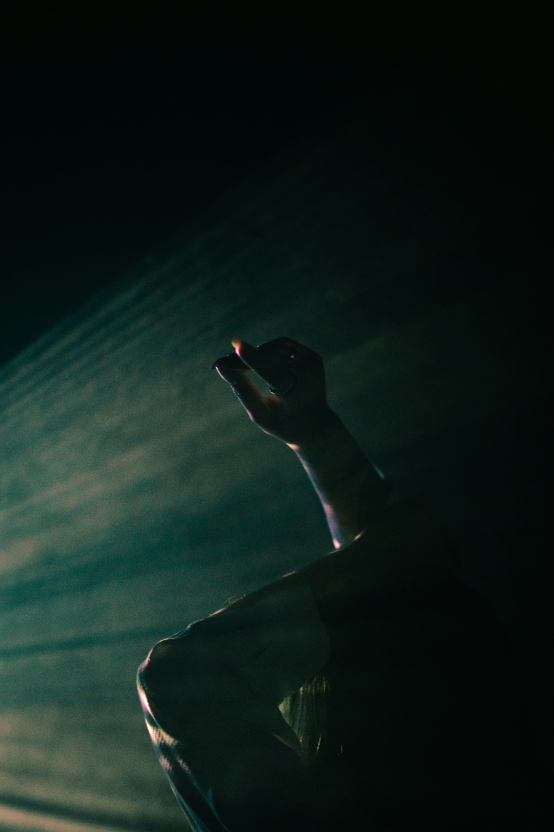 A captivating moment from a narrative performance featuring expressive actors under moody lighting, highlighting the emotional depth.