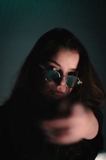 Side profile of a person wearing Maison Madonna glasses, their gaze hidden yet powerful.