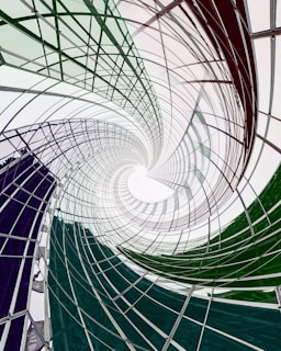 distorted and spiralling image of white and green metal construct 