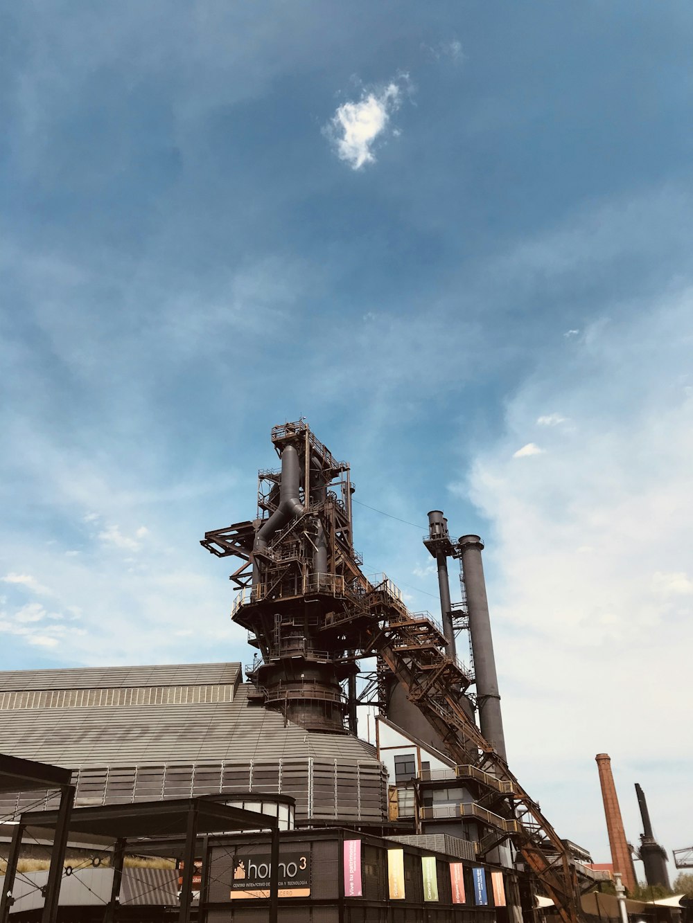 brown metal statue under blue sky during daytime