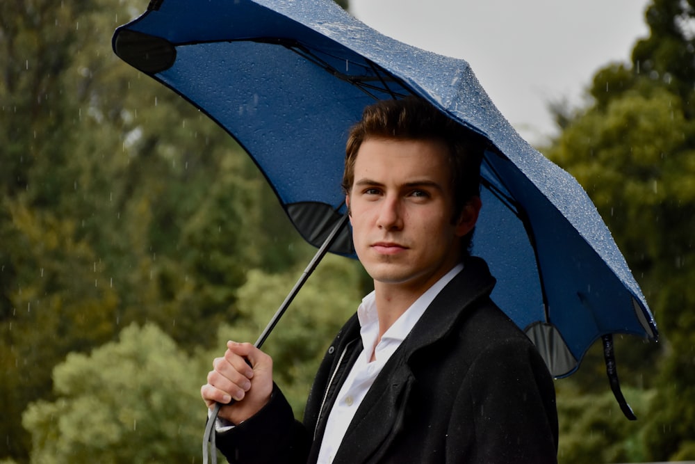 woman in black blazer holding umbrella