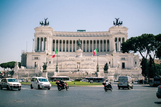 cars parked in front of white building in Piazza Venezia Italy