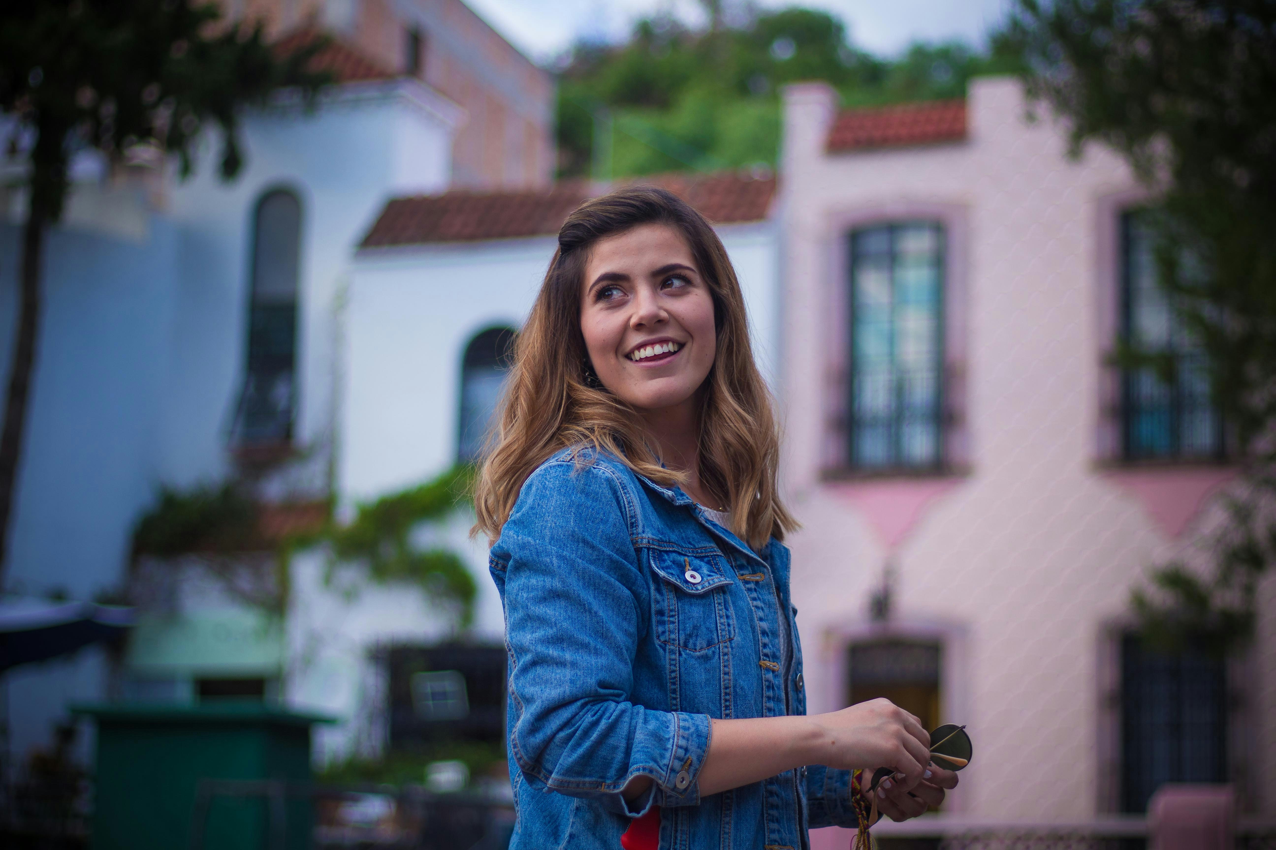 woman in blue denim jacket smiling