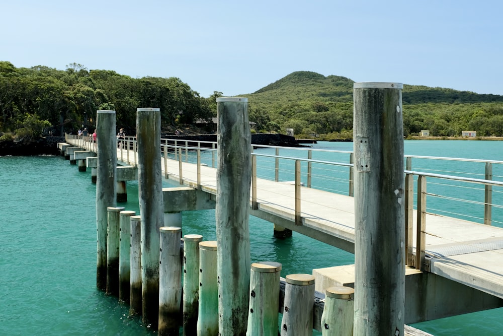 brown wooden dock on blue sea under blue sky during daytime