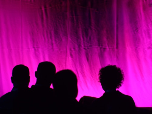 silhouette of people standing on stage