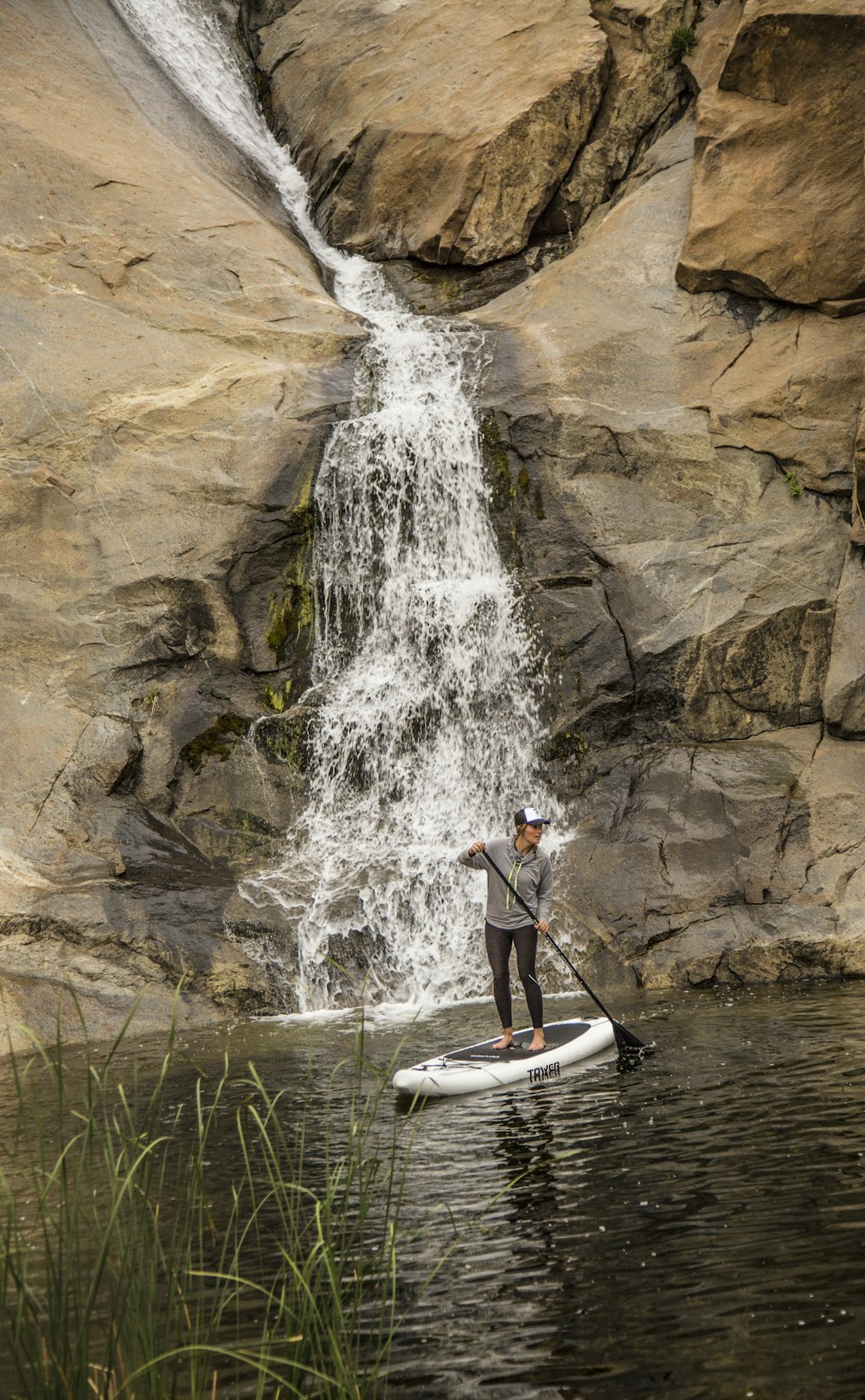 man in white and black wet suit riding white kayak on river during daytime