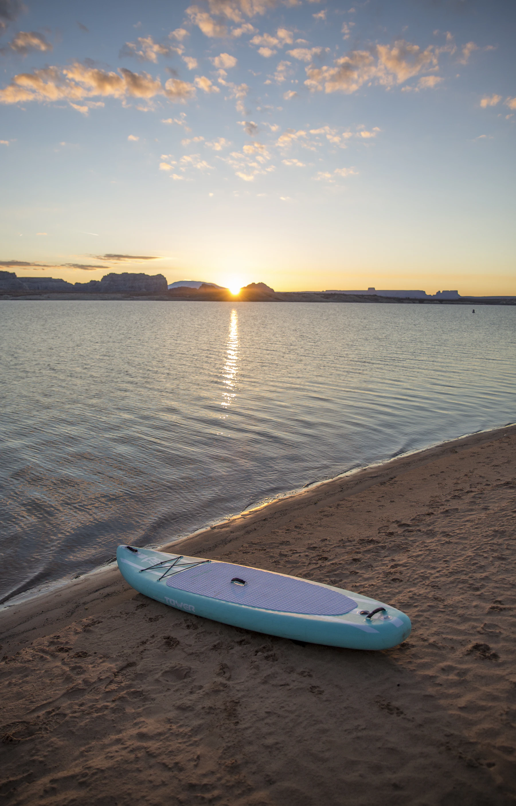 Paddle board beside shoreline rocks for a quiet outdoor water session