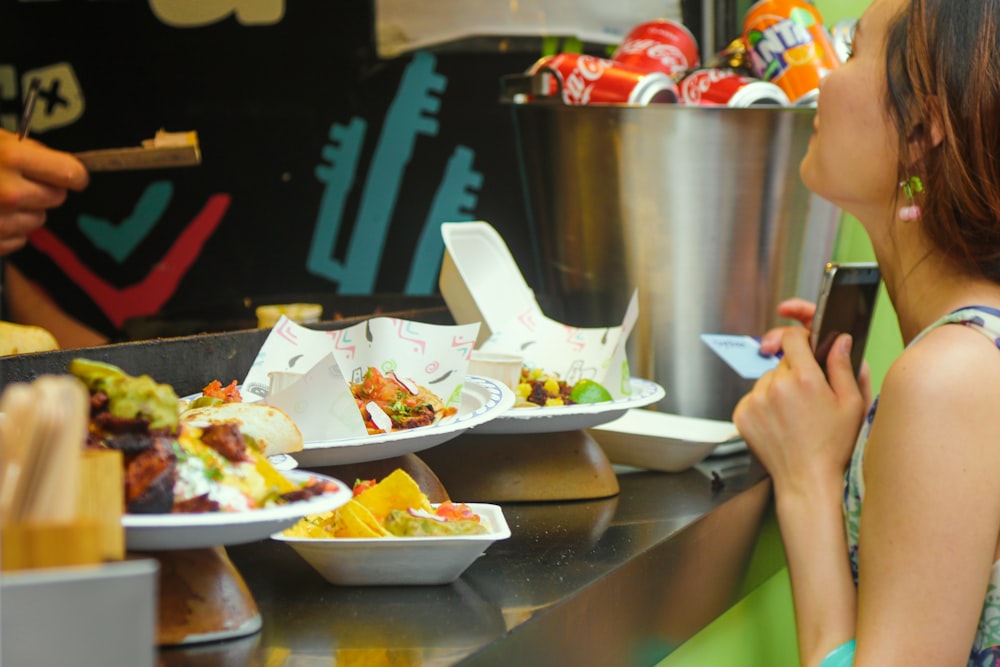 person holding white ceramic bowl with food