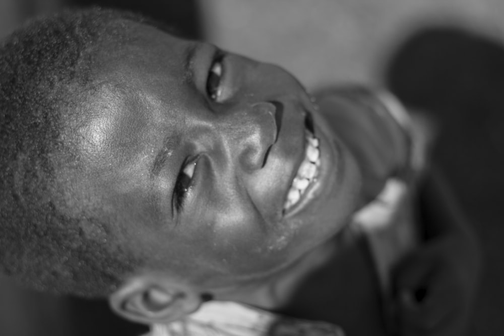 grayscale photo of man smiling