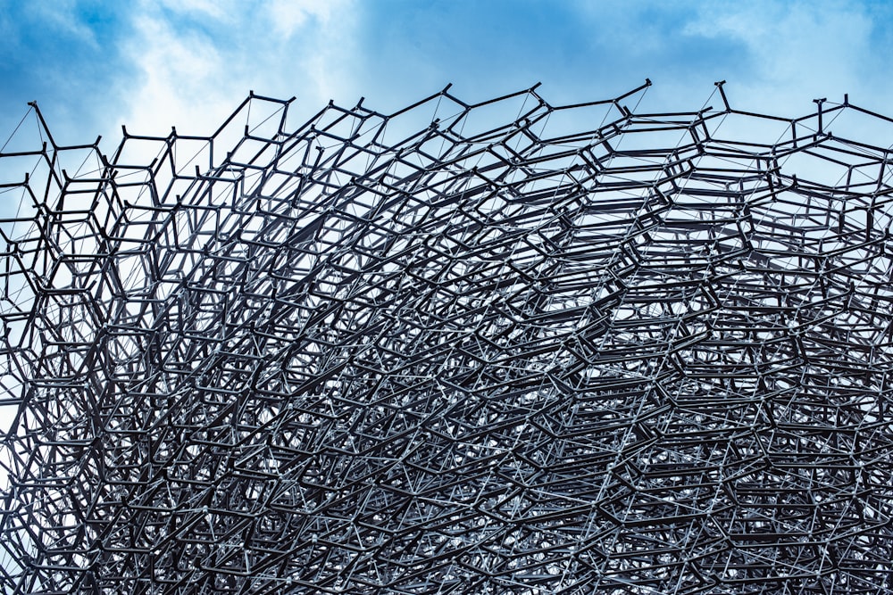 gray metal chain link fence under orange and blue cloudy sky