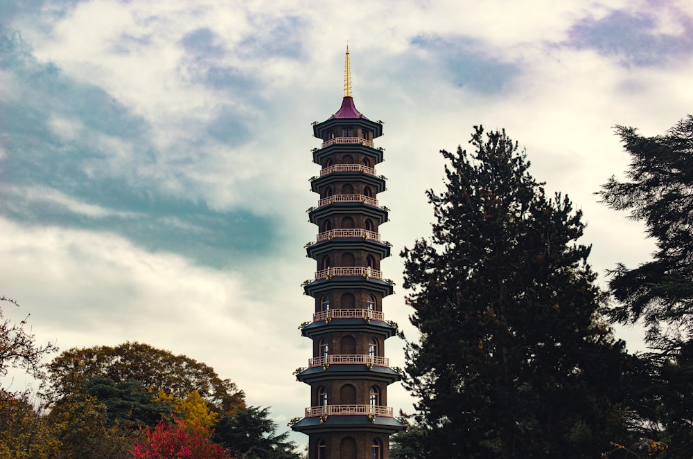 brown and black tower under cloudy sky during daytime