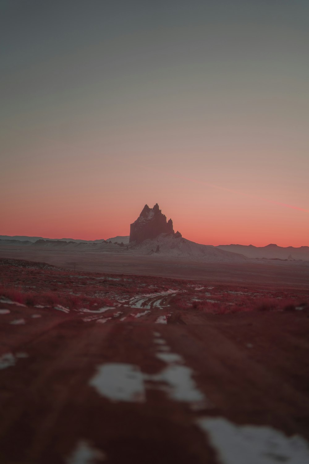 brown rock formation on the beach during sunset