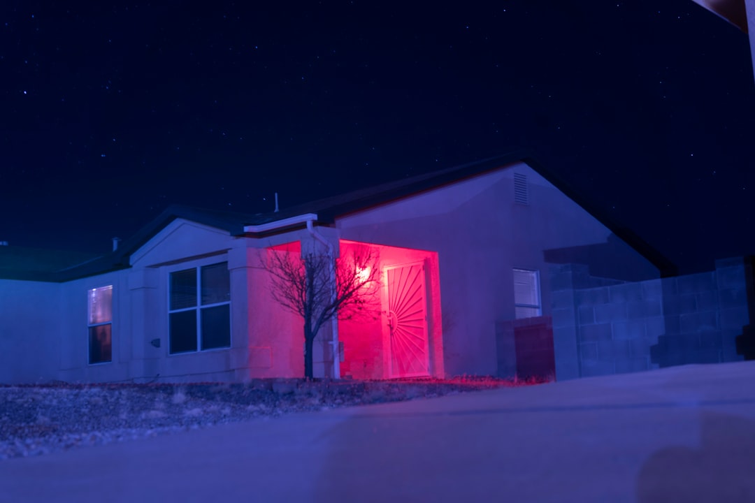 white and red house with lights turned on during night time