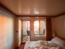 A cozy hotel room featuring a king-size bed and ocean views.