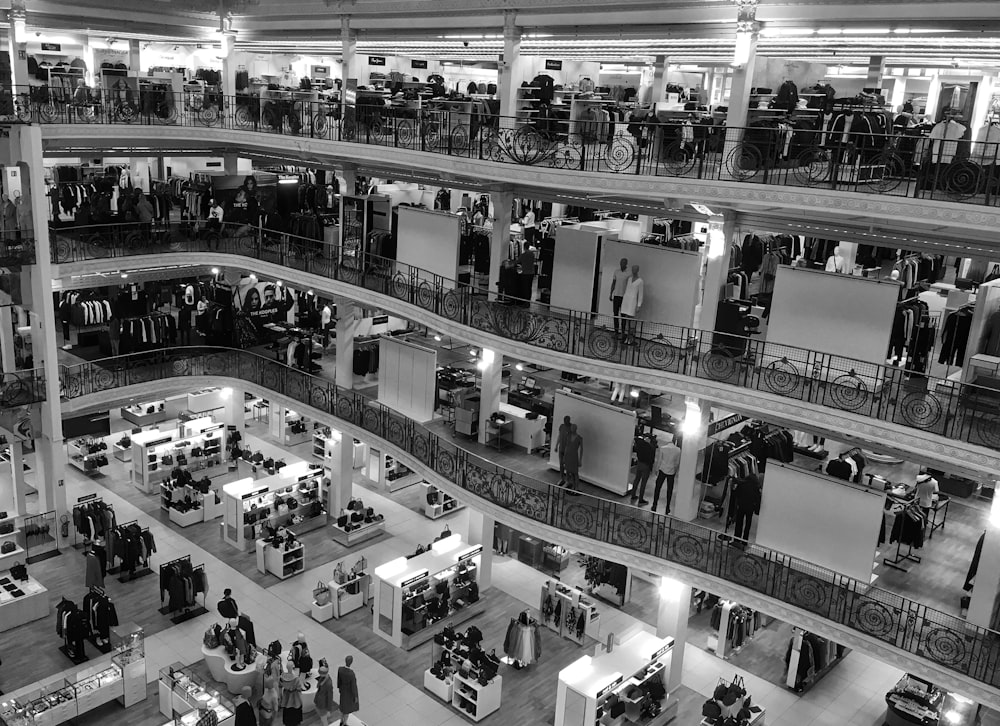 people walking inside building with escalator