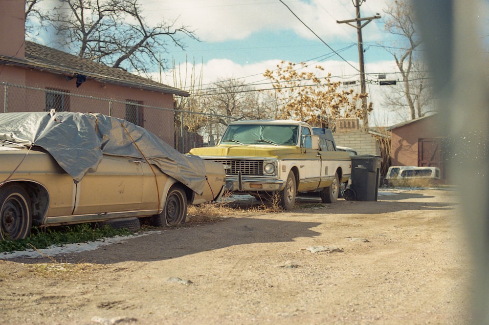 brown vintage car parked beside brown bare tree during daytime