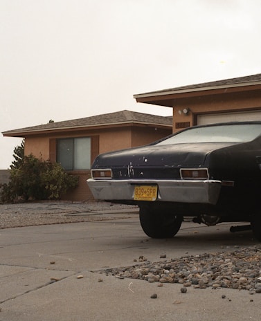 Photo of a car parked safely in front of a home, illustrating vehicle protection.