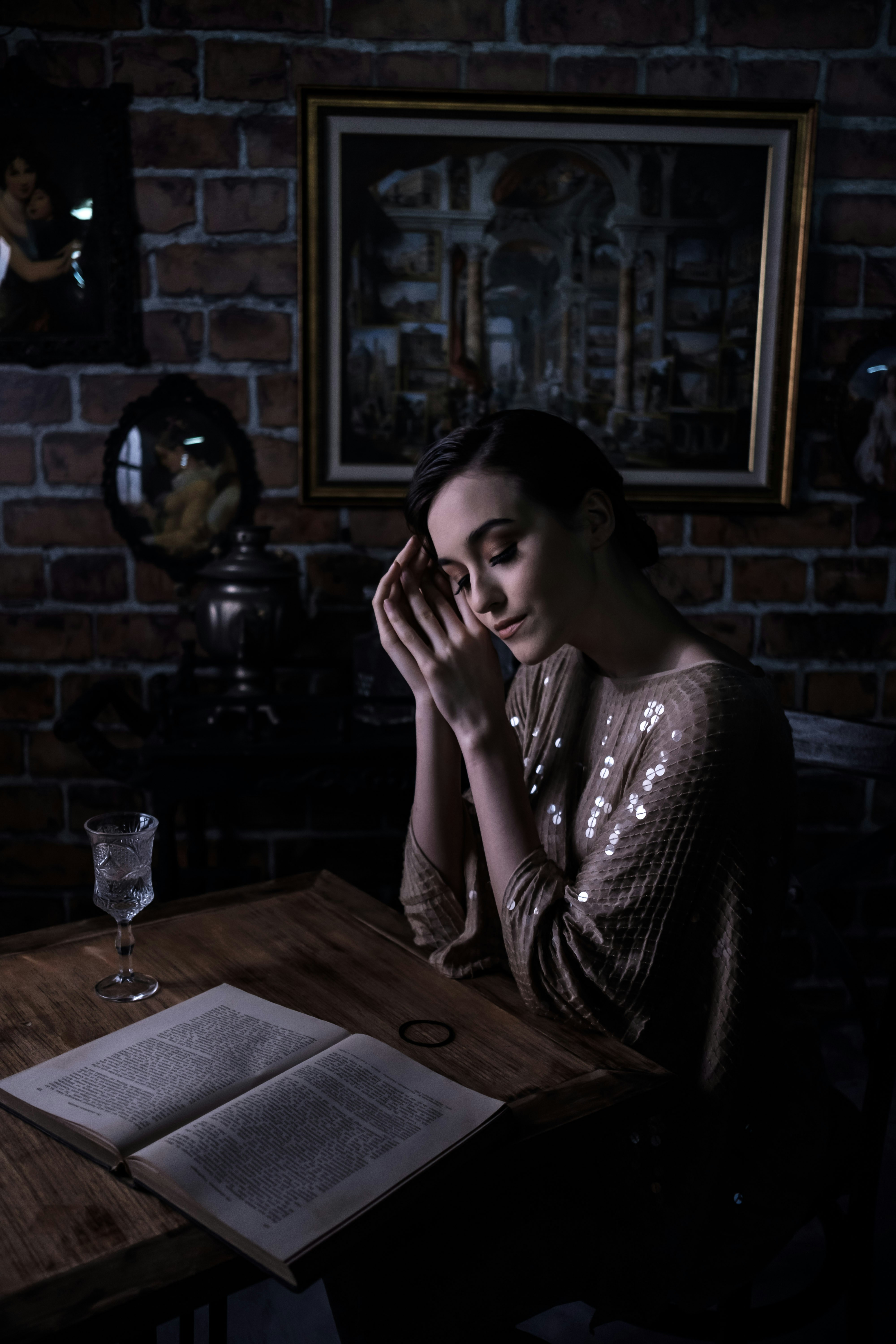 woman in black and white floral dress sitting on chair