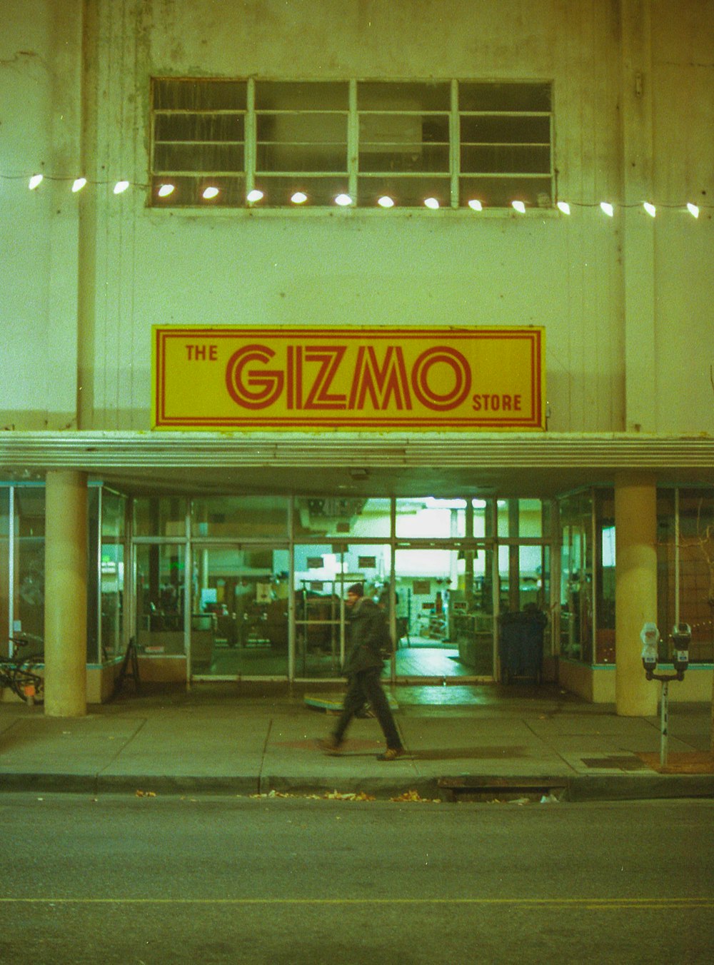 man in black coat walking on sidewalk near building during daytime