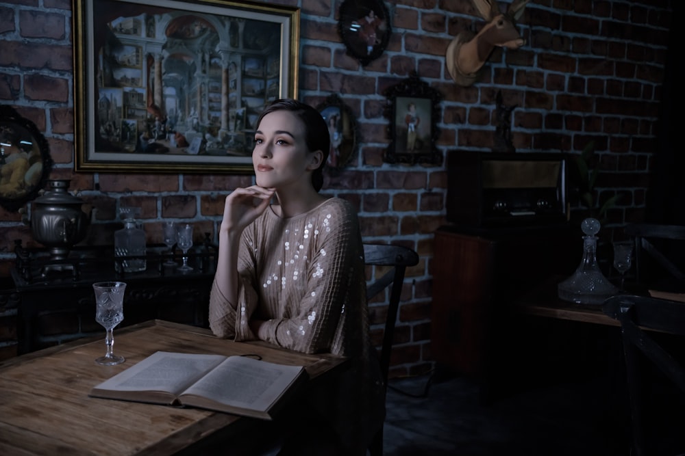 woman in white and black long sleeve shirt sitting on chair