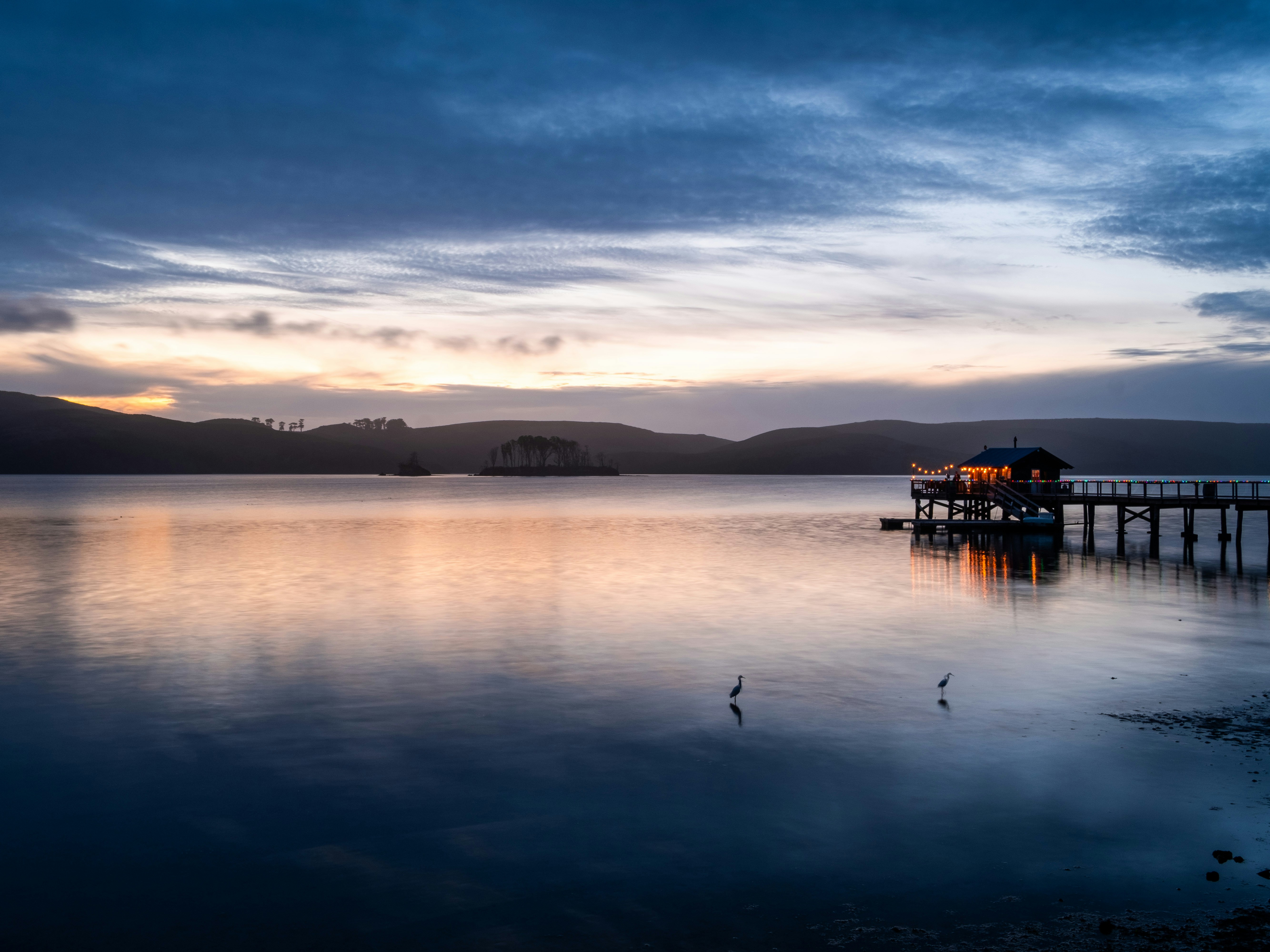 silhouette of a boat on water during sunset, Sunset at Nick’s Cove on Tomales Bay