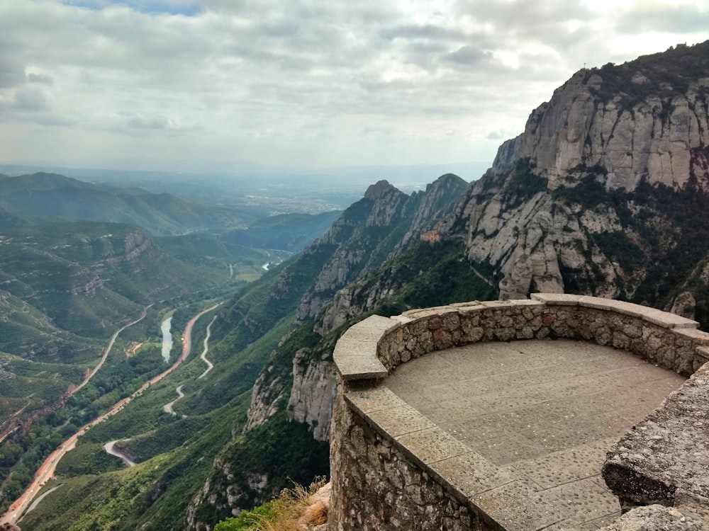 brown concrete bridge on top of mountain during daytime