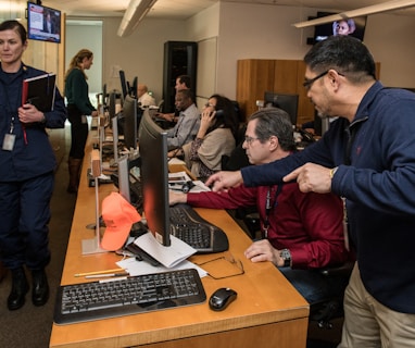 man in blue jacket using computer