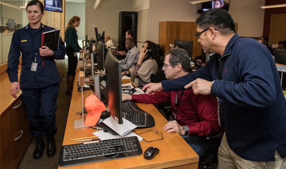 man in blue jacket using computer