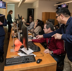 man in blue jacket using computer